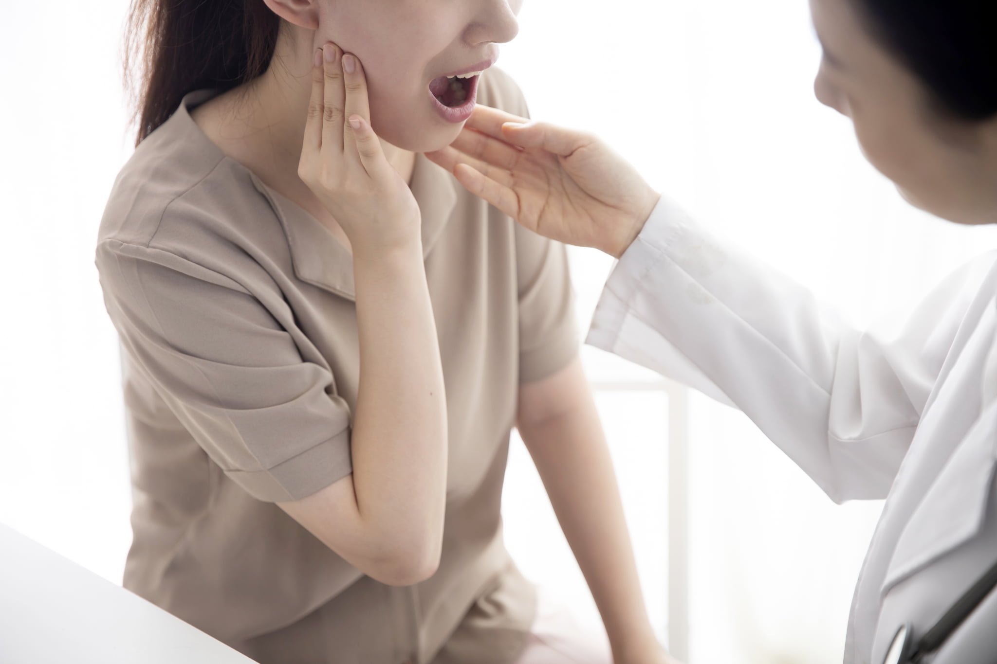 顎が痛くなり口腔外科を受診する女性